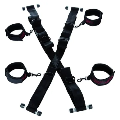 Black restraints with adjustable straps and buckles, arranged in an X-shape.