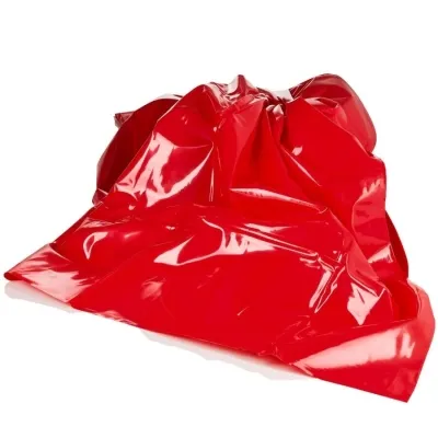 Red, shiny, crumpled pile of fabric on a white background.