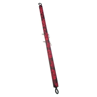 Red and black padded rod with hooks at both ends, decorated with floral patterns.
