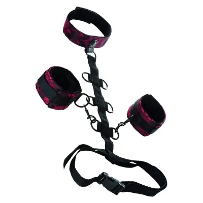 Black and red handcuffs and leg irons with connecting straps and buckles.