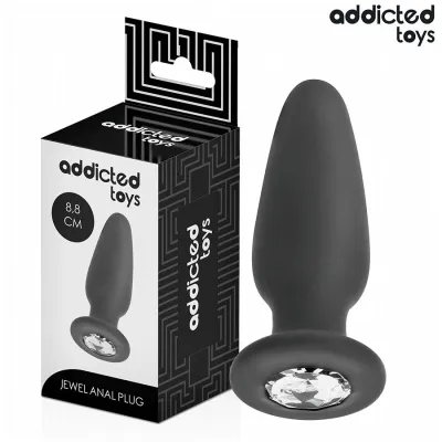 Black anal plug with gemstone, 8.8 cm, next to packaging from Addicted Toys.
