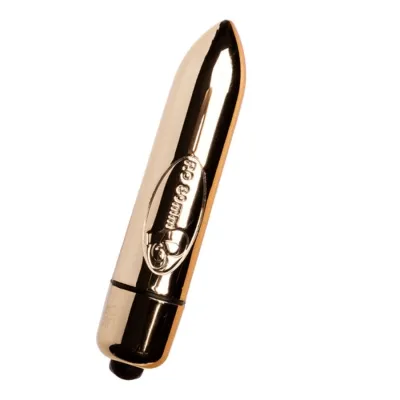 Goldener, zylindrischer Vibrator mit abgerundeter Spitze und schwarzem Knopf am Ende.