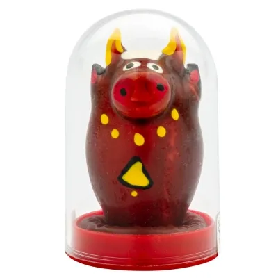 Red bull figure with yellow dots and triangle, under a transparent dome on a red base.