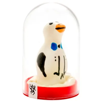 White penguin figurine with black and blue details in a transparent dome on a red base.