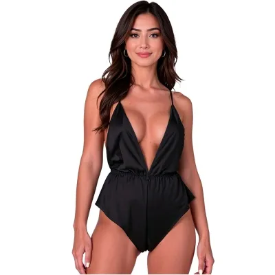Woman in a black, low-cut jumpsuit against a white background.