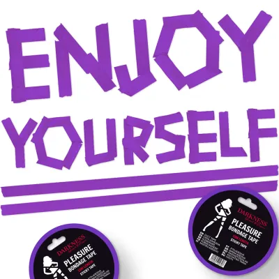 Purple lettering "ENJOY YOURSELF" made of adhesive tape, underneath two rolls of bondage tape.