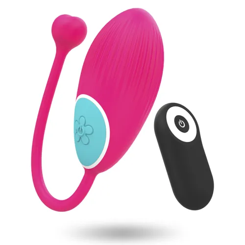 Pink vibrator with remote control, blue button and heart detail, floating against a white background.