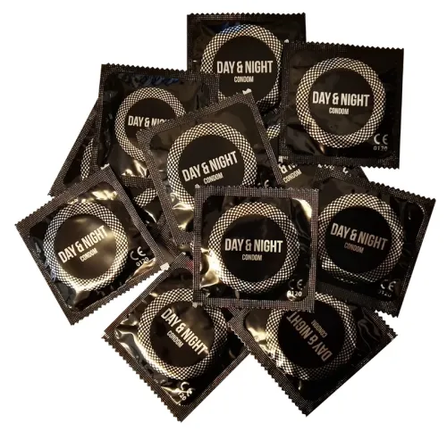 Several black condom wrappers labeled "Day & Night" arranged in a stack.