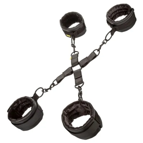 Black handcuffs and ankle cuffs with soft inner lining, connected by adjustable straps and metal rings.