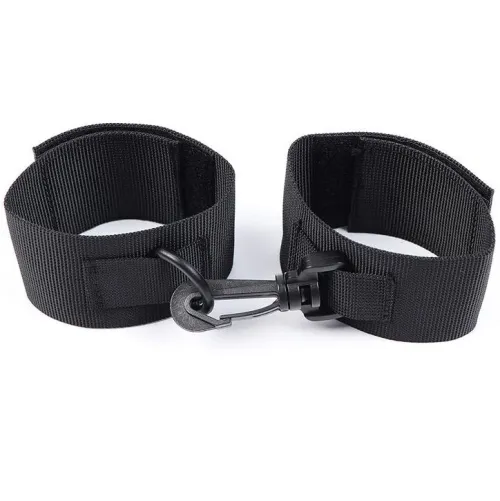 Black nylon handcuffs with Velcro closure and carabiner hook on a white background.