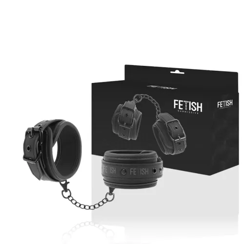 Black handcuffs with chain in front of a package labeled "Fetish Submissive".