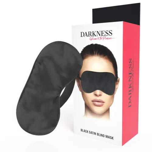 Black satin eye mask in front of packaging printed with "Darkness".