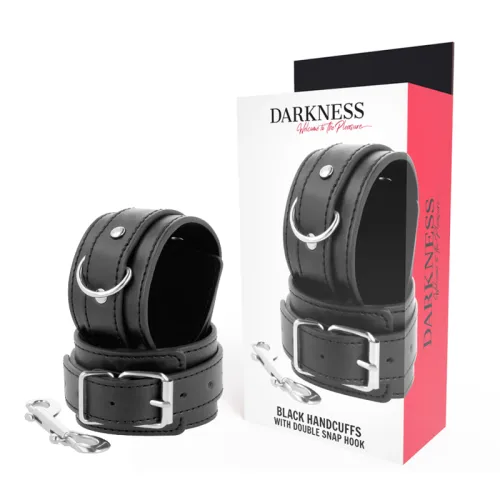 Black handcuffs with D-ring and buckle, packaging with "Darkness" logo, double carabiner hook next to it.