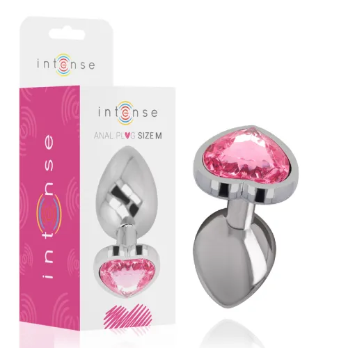 Silver anal plug with pink heart-shaped stone, packaging in the background.