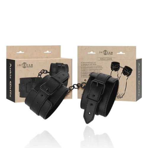 Black vegan leather ankle cuffs with packaging in the background, brand "Intense Fetish".