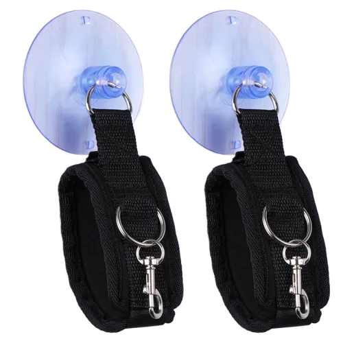 Two black handcuffs with suction cups and metal rings, arranged side by side.