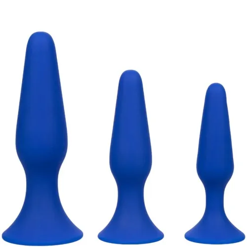 Three blue silicone plugs of different sizes, lined up next to each other.