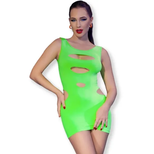 Person in a neon green dress with cut-outs, red lipstick and earrings, posing in front of a white background.
