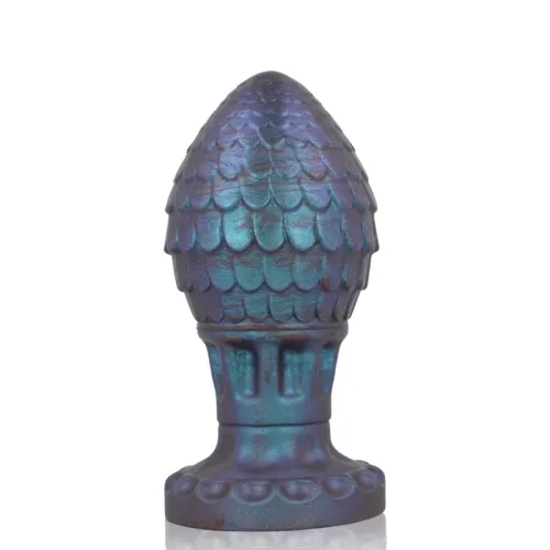 Blue-purple sculpture with a scale-like surface and wide base, reminiscent of a pine cone.