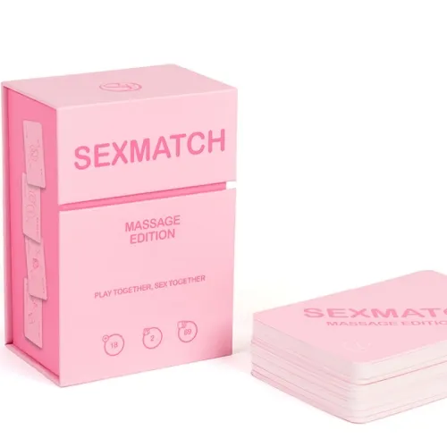 A pink card game box labeled "Sexmatch Massage Edition", with a stack of cards next to it.