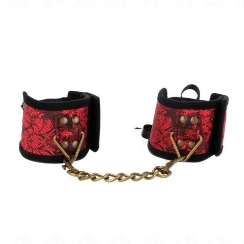 Red handcuffs with a black pattern and gold chain, on a white background.