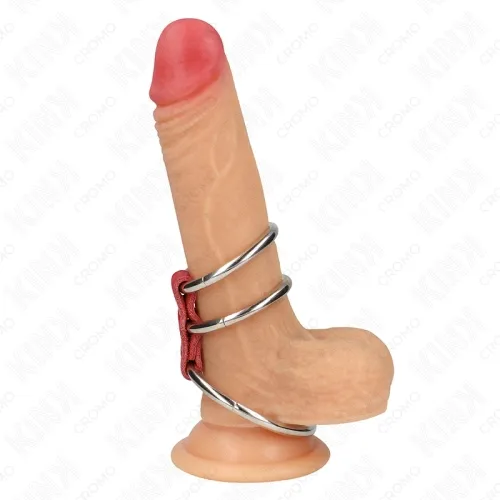 A dildo with a suction cup and three metal rings attached to a red band.