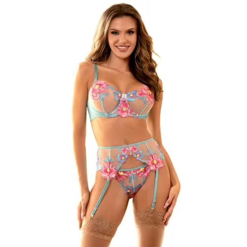 Woman in a colorful, floral lingerie combination with garter belt and lace stockings, smiling against a white background.