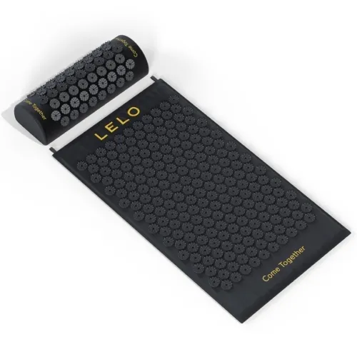 Black acupressure mat and pillow with grey tips, yellow lettering "LELO" and "Come Together".