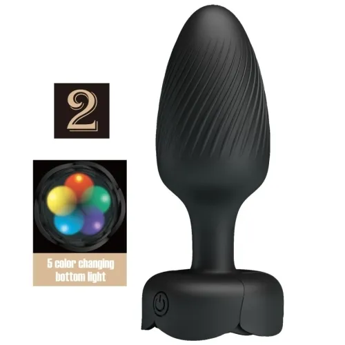 Black, textured massage device with color-changing light and on/off switch.