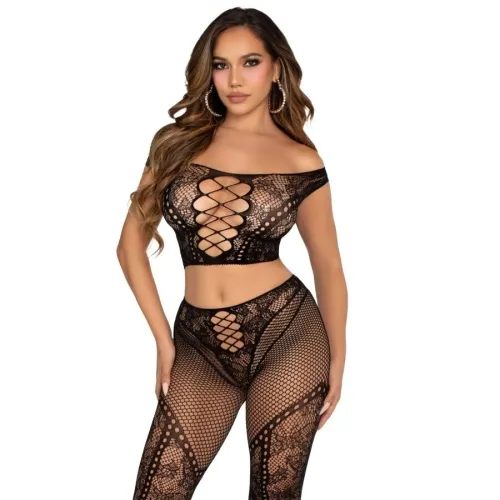 Woman in black, openwork lace outfit with off-the-shoulder top and mesh leggings, posing in front of a white background.