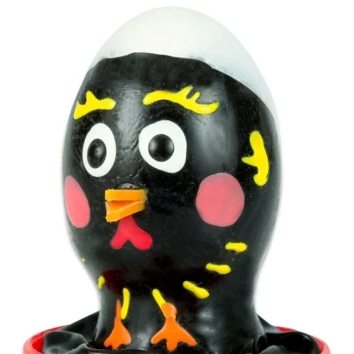 Black chocolate egg in the shape of a chick with yellow details and a red beak.