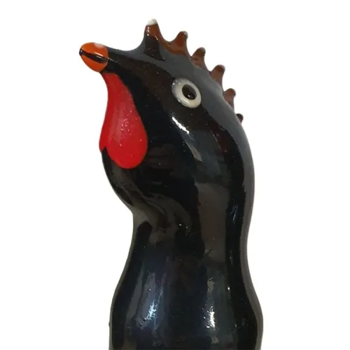 Black glass figurine of a rooster with a red comb and beak, viewed from the side.