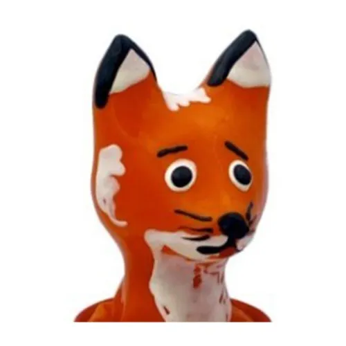 Ceramic figure of a fox with large eyes and orange and white paintwork.