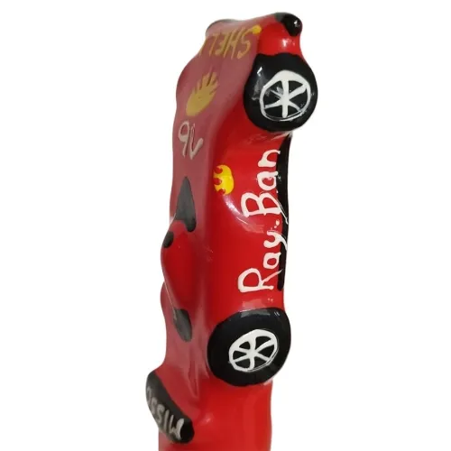 Red model car with the inscriptions "Ray Ban" and "Shell", black wheels, decorative painting.