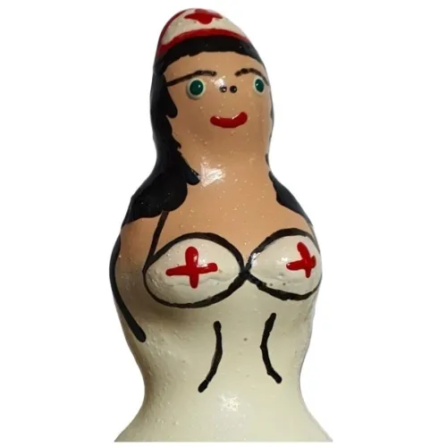 Figur einer Krankenschwester mit weißer Uniform und roten Kreuzen, schwarze Haare, grünen Augen, roter Mund.