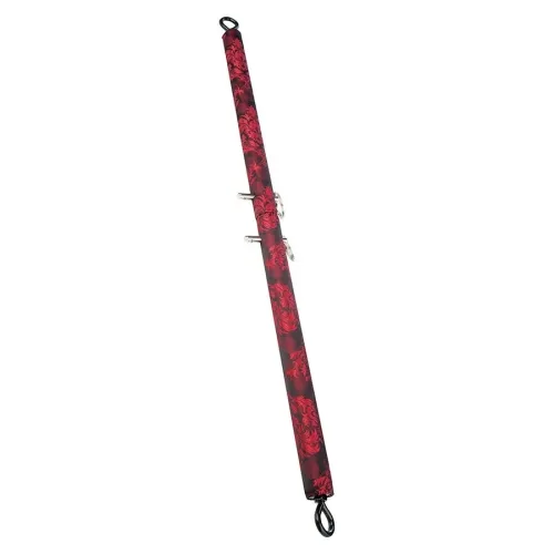 Red and black padded rod with hooks at both ends, decorated with floral patterns.