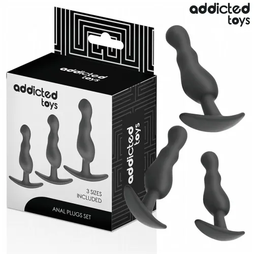 Black anal plug set in three sizes from Addicted Toys, with packaging in the background.