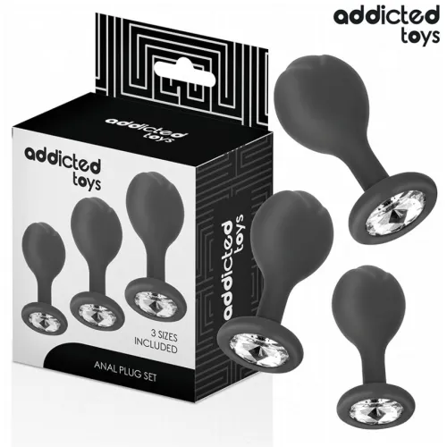 Black anal plug set in three sizes, decorated with crystals, next to the packaging of "Addicted Toys".