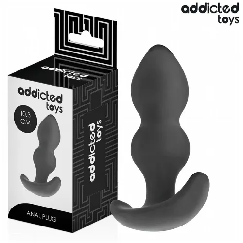 Black anal plug from Addicted Toys, 10.3 cm, next to the packaging with geometric pattern.