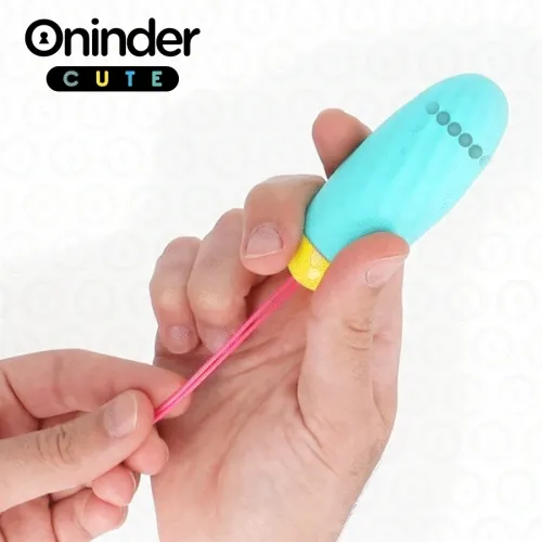 A person is holding a small, blue device with a yellow end and a pink strap.