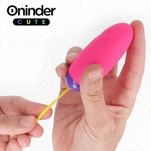 Hand holding pink, oval device with yellow cable, labeled "Oninder CUTE".