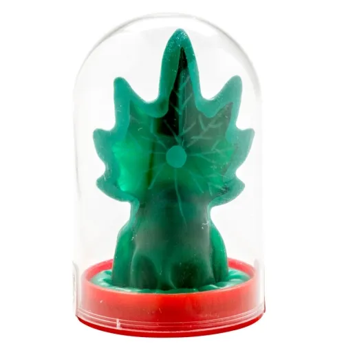 Green candle in the shape of a Christmas tree under a transparent dome with a red base.