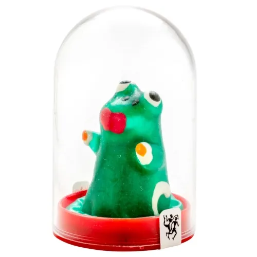 A green, cartoon-like figure in a transparent dome with a red base, featuring large eyes and red lips.