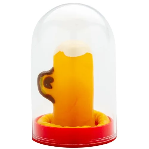 Yellow candle in the shape of a beer mug with foam, under a transparent dome on a red base.