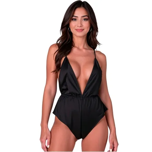 Woman in a black, low-cut jumpsuit against a white background.