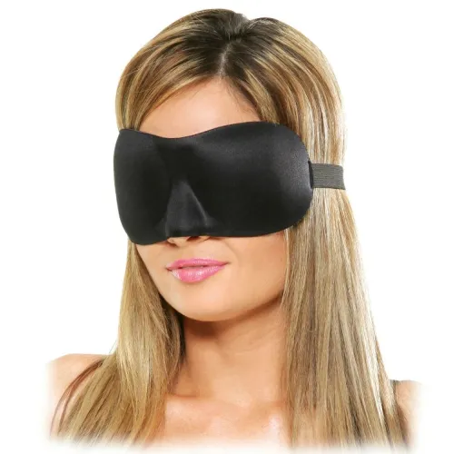 A woman with blonde hair is wearing a black sleep mask.