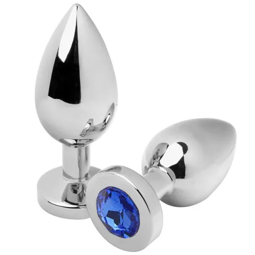 Two silver butt plugs, one standing, one lying down, with a blue gemstone at the base.