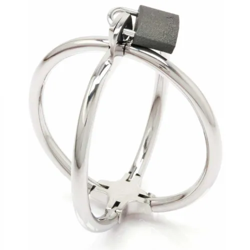 Silver metal puzzle with interlocking rings and a black cube on top.