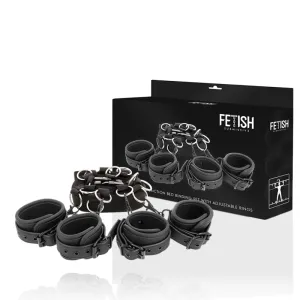Schwarzes Bondage-Set mit verstellbaren Ringen, vor einer Verpackung mit Produktabbildung.