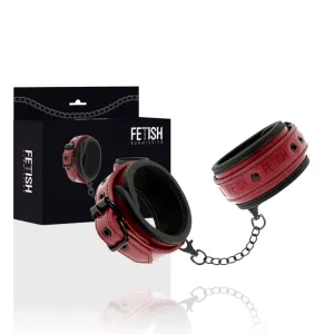 Rote Leder-Handfesseln mit Kette, Verpackung im Hintergrund, Aufschrift 